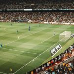 green soccer field inside stadium